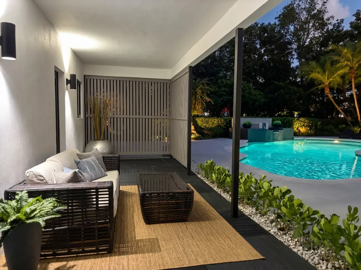 Covered patio sofa at evening with pool visible beyond