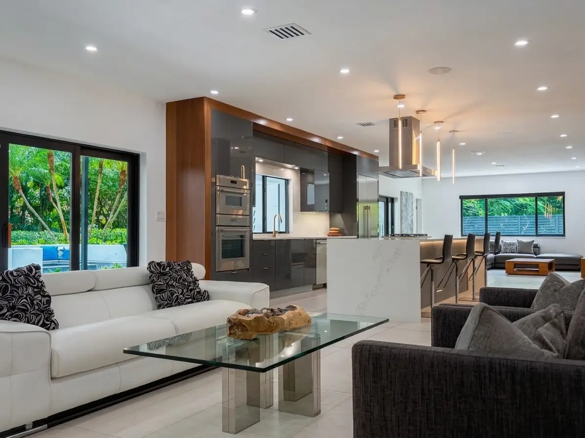 Open floor plan living room with large-format Spanish porcelain flooring and natural light